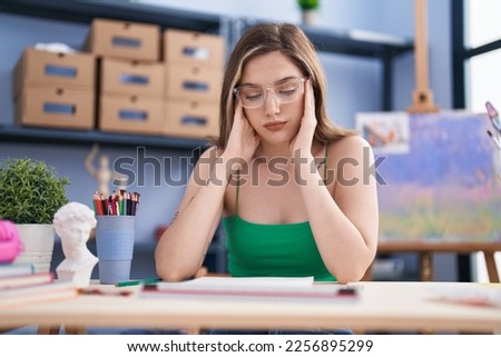 Young woman artist stressed drawing at art studio