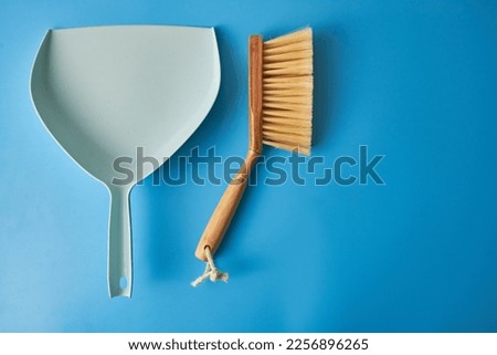 Set with  hand brooms and dustpans on blue background, top view. Banner design