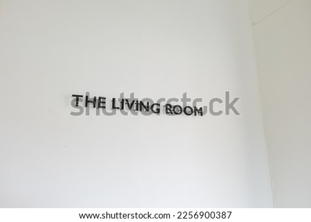 living roomsign on wall in living room.