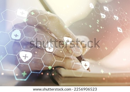 Creative abstract medical hologram and woman hand writing in diary on background, online medical consulting concept. Multiexposure