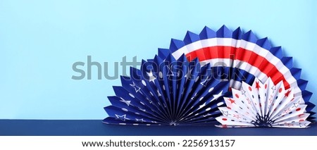 American paper fans on a blue background. Banner design for 4th of July, President's Day and other US national holidays.