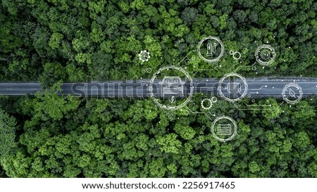 Eco car on forest road going through forest, Ecosystem ecology healthy environment road trip travel, Eco car with nature, Electric car and earth EV electrical energy for environment. Royalty-Free Stock Photo #2256917465
