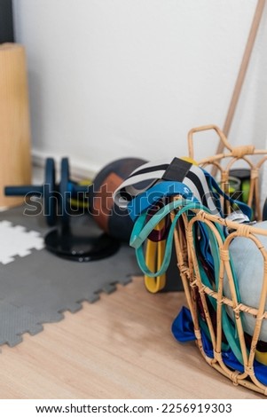 sports equipment on the floor, sports rubber bands, basket with inventory