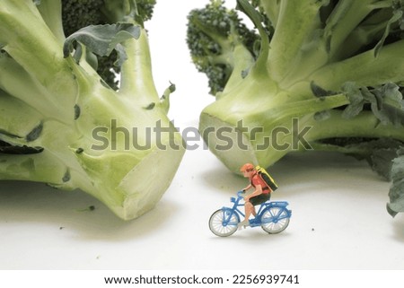 figure man on bike in green Broccoli