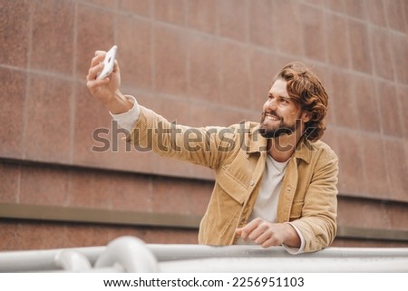 millennial man taking selfie outdoors, good looking man, hipster