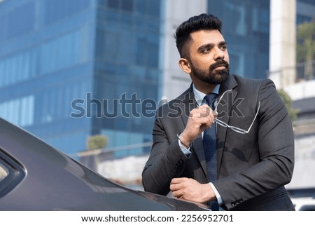 Indian businessman and businesswoman using digital tablet on city street