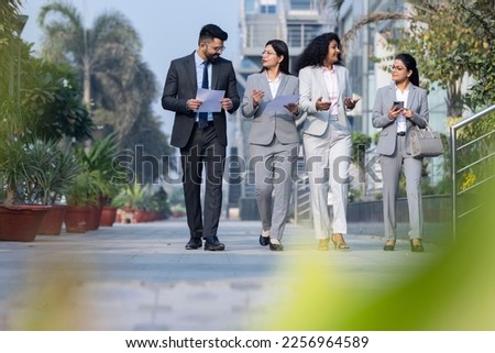 Business colleagues discussion outside office building.