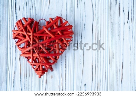 a red heart on a white wooden background. The concept of Valentine's Day. Top view, meto below text Royalty-Free Stock Photo #2256993933
