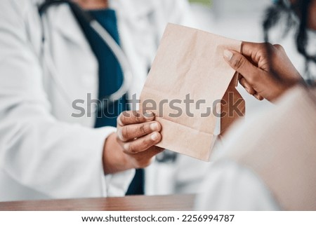 Pharmacy, medication and pharmacist giving bag to a patient for treatment, cure or remedy. Healthcare, people and woman with a brown paper package from a chemist for medicine in a drugstore or clinic Royalty-Free Stock Photo #2256994787