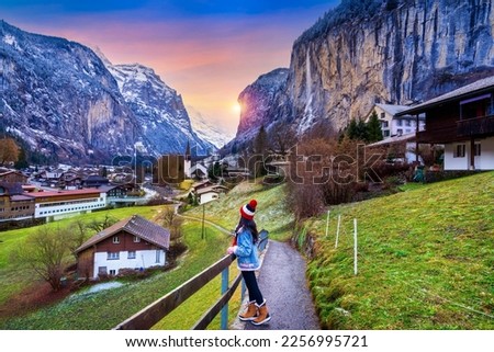 Tourist visiting village of Lauterbrunnen in the Bernese Oberland, Switzerland. Royalty-Free Stock Photo #2256995721
