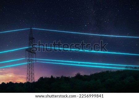 Electric transmission tower with glowing wires against the starry sky background. High voltage electrical pylon. Energy concept. Royalty-Free Stock Photo #2256999841