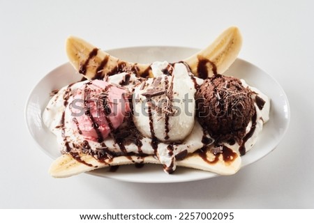Top view of plate with colorful ice cream scoops and banana slices served on white background Royalty-Free Stock Photo #2257002095