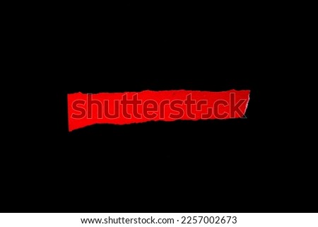 Blank torn paper isolated on black background. Top view of red paper piece with copy space.