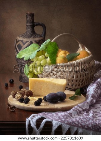 Still life with cheese and fruits