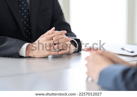 A man in a managerial position interviewing an employee Royalty-Free Stock Photo #2257012027