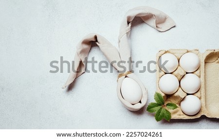 Easter in napkin egg decoration on white background and green fresh branch. The concept of family decorating the house for the holiday Easter