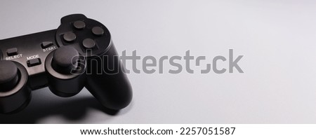 wireless gamepad from a game console on a gray background. Horizontal banner