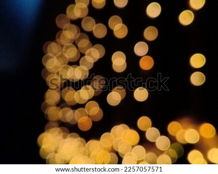 abstract Bokeh lights background image with blue spotlight for templates and beautiful backdrops.blurred hanging lights isolated over black for further editing purposes.round lights bokeh effect.