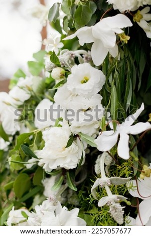 Flower composition with green and white flowers. Wedding arch with eustoma, mint, peonies and green leaves