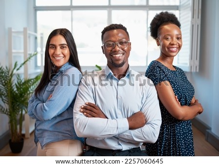 Group of smiling business people pose arms folded in office, diverse trio Royalty-Free Stock Photo #2257060645