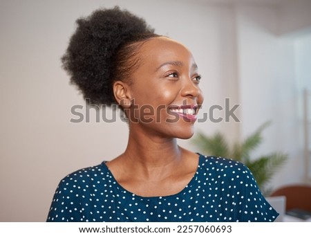 Close up of young Black business woman smiling and looking away Royalty-Free Stock Photo #2257060693