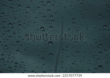 Raindrops sliding down the glass