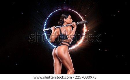 Girl athlete, bodybuilder. Back view. Download a photo to design an advertisement for a gym or a sports club