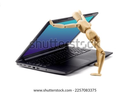 A wooden artist's human mannequin opening the cover of a notebook computer keyboard, suggesting or parodying artificial intelligence, isolated on white