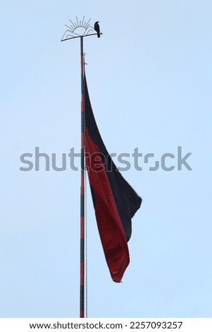 flag post with the symbol of sun rise.