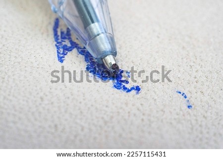Ballpoint pen tip, scribbling on a white leather sofa, or car seats. Royalty-Free Stock Photo #2257115431