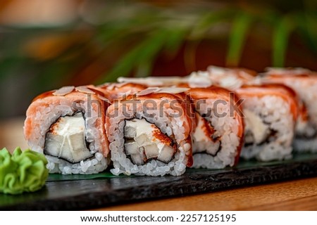 Sushi rolls with grilled salmon and pear. Japanese dish of fresh salmon and rice
