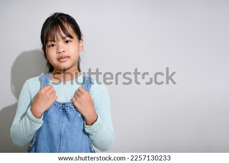 Girl Asian blue clothes , gray background lighting studio 