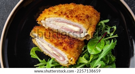 cordon bleu cutlet chicken meat, cheese, bacon meal snack on the table copy space food background rustic top view Royalty-Free Stock Photo #2257138659
