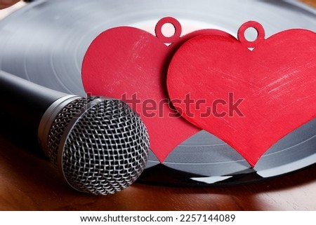 Vinyl plate. Nostalgic songs, concept with vinyl records, microphone and hearts. Royalty-Free Stock Photo #2257144089