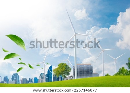 wind turbine farm and green leaf blowin in smart city.renewable energy.sustainable and environmentally friendly. Royalty-Free Stock Photo #2257146877