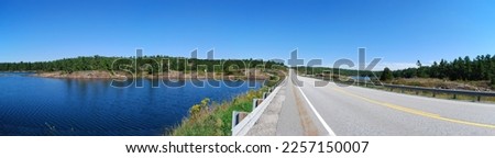 A beautiful highway scene in panorama in Manitoulin, ON, Canada
