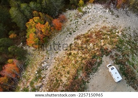 Drone aerial view of parked big modern camper motorhome. Family vacation travel RV. Bicycles attached to a caravan. Travel and adventure. Go everywhere concept.