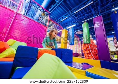Baby girl playing at indoor play center playground.  Royalty-Free Stock Photo #2257152839