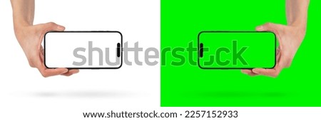 Phone in hand on a white background. A woman's hand holds a new modern phone in her hand on a white background with a blank white screen. Smartphone isolated on green background with green screen.