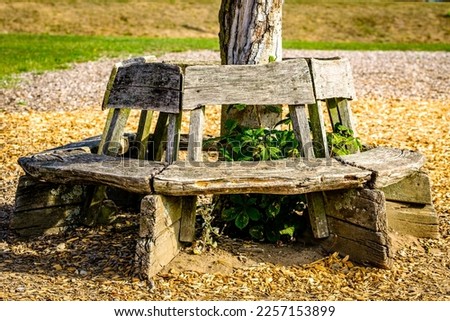 typical old wooden bench - parkbench - photo Royalty-Free Stock Photo #2257153899