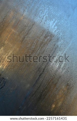 Condensation drops on the glass. vertical wet glass background