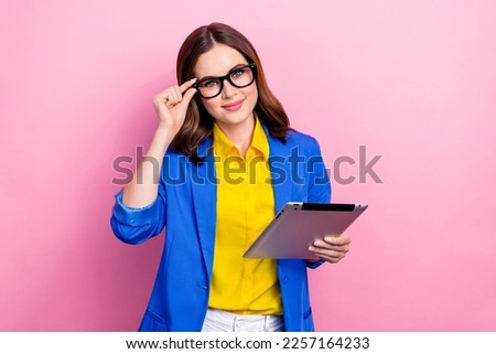 Photo of young confident business lady touch glasses wear stylish ukrainian style formal outfit hold lenovo tablet isolated on pink color background