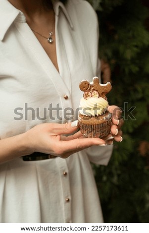 Women holding cupcakes. Cupcake on hands. Small cupcake with cream. White muffin in hands. Hand product model for food photography. Food and hands. Holiday dessert.