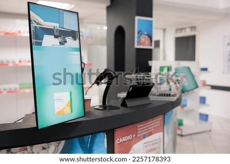 Empty pharmacy counter desk equipped with store display and computer ready for clients to come and buy pharmaceutical products. Drugstore filled with pills packages and supplements, vitamins Royalty-Free Stock Photo #2257178393