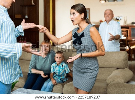 Quarrel between husband and wife in a large family. High quality photo Royalty-Free Stock Photo #2257189207