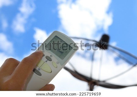 Hand held remote control, direct to cloudy sky