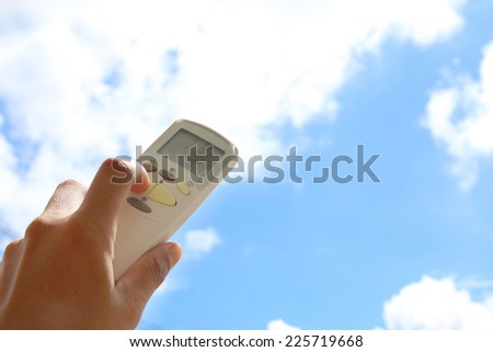 Hand held remote control, direct to cloudy sky