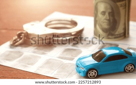 Traffic court handles cases related to violations of traffic laws such as speeding, reckless driving, and DUI. Car and police handcuff on fingerprint crime page file.	  Royalty-Free Stock Photo #2257212893