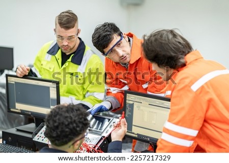 Electrical engineers supervise and design PLC electrical systems for companies or industrial factories. Royalty-Free Stock Photo #2257217329