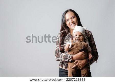  Latin American mom with her baby. Mother's Love. Baby smiling. Single mother and her son. Mother and baby very happy. Young mother holding her baby. Royalty-Free Stock Photo #2257219893